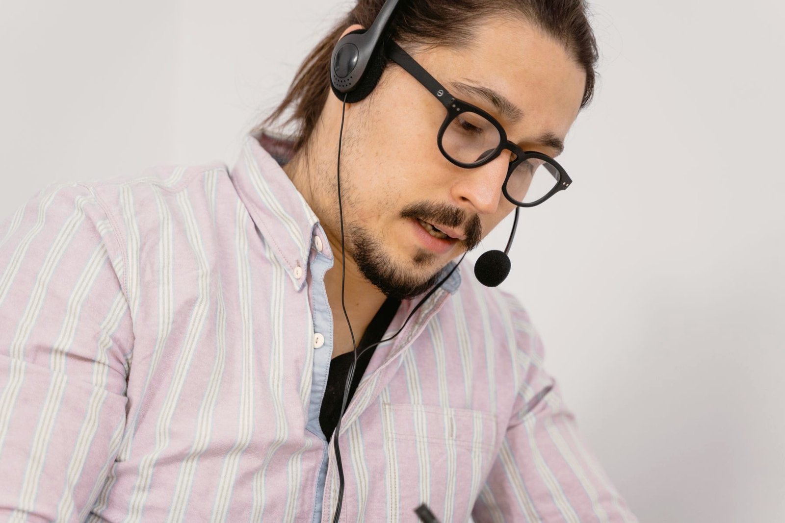An operator in glasses concentrating on a call